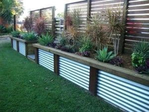 Corrugated Steel Panels Installed Vertically As Landscape Border