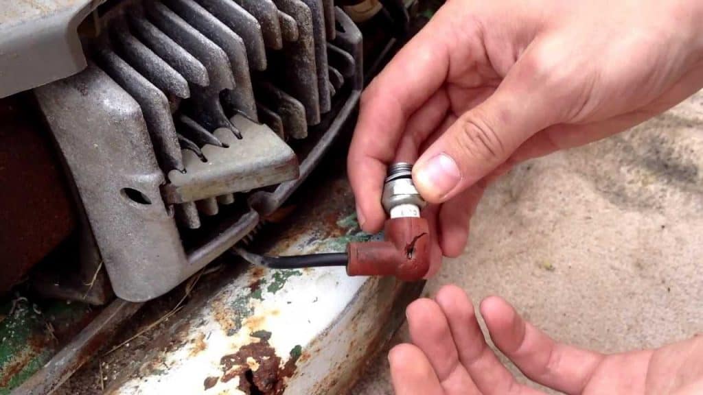 Cleaning the engine spark plug of Lawn Mower