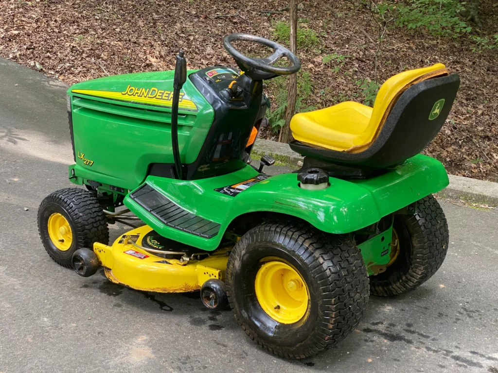 John Deere S240 with problems tractor on green lawn