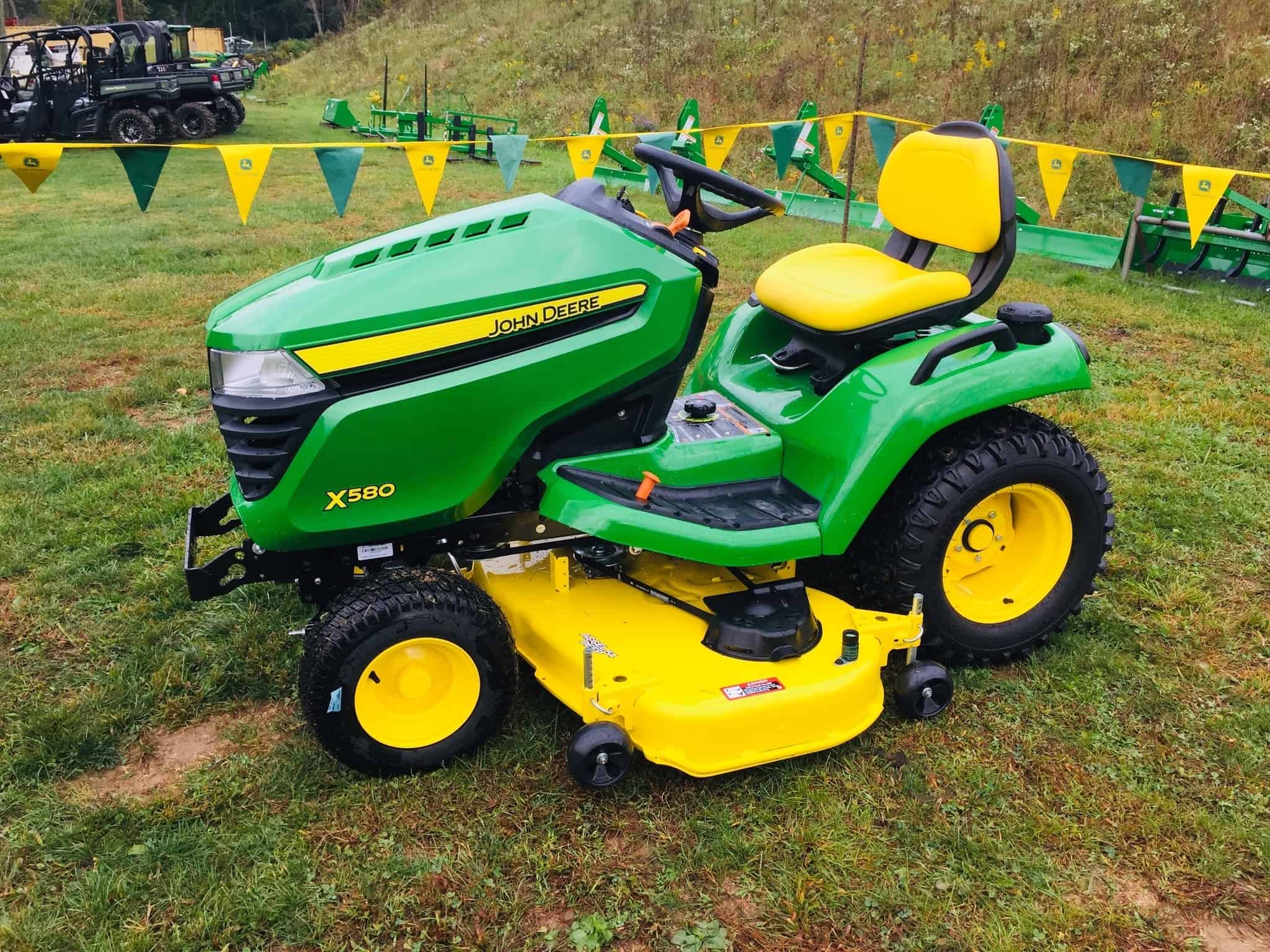 john deere x580 with problems tractor on green lawn