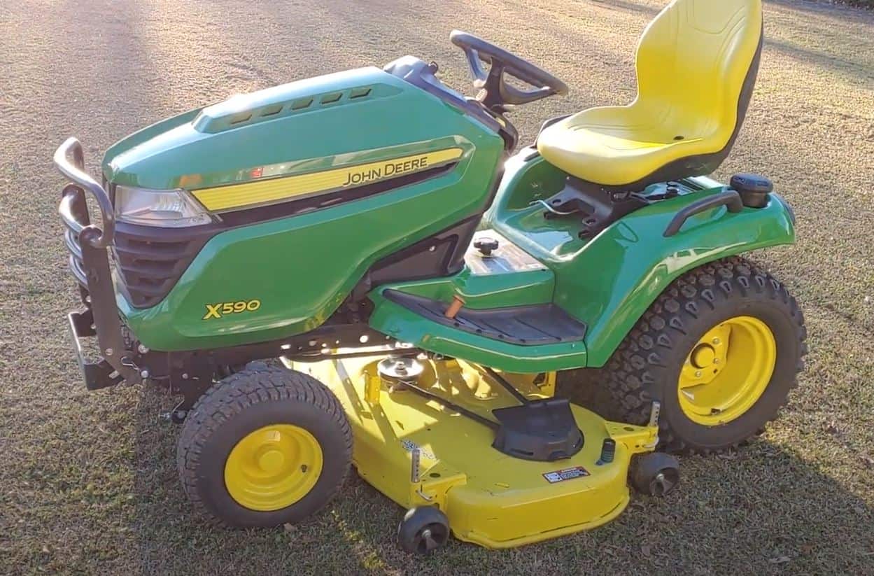 john deere x590 with problems on lawn yellow grass sunset